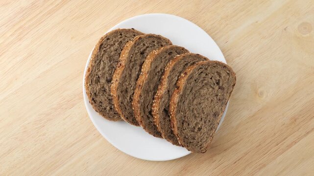 Sliced whole wheat bread rotating on a plate