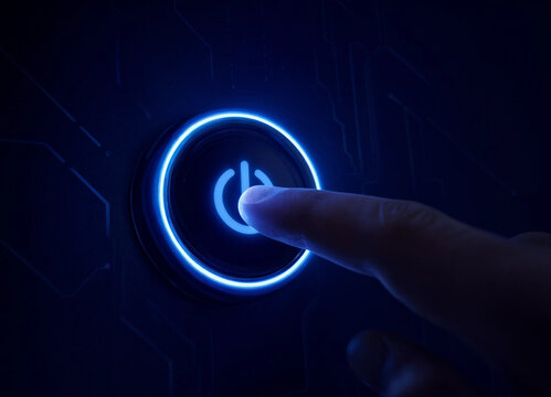 A human finger pressing a glowing blue power button on a futuristic digital circuit board interface background