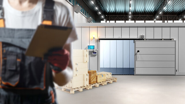 Warehouse, Cold storage. Technician inspects refrigerated warehouse equipment with a clipboard while monitoring loading operations, temperature control, storage and logistics processes.