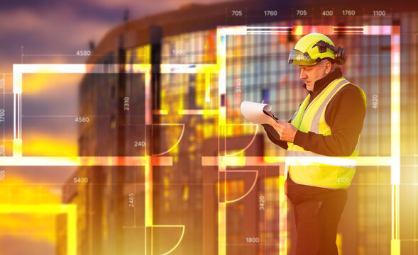 Construction supervision. Building inspector reviews architectural plans during a commercial construction project, verifying design compliance and site development progress.