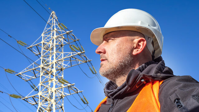Power transmission. Electrical engineer inspects high-voltage transmission lines and power grid infrastructure, supporting network reliability, maintenance and energy distribution.