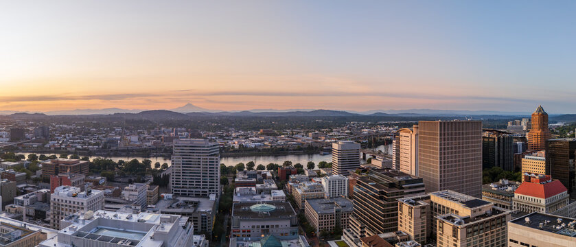 Aerial view of the Portland skyline at sunrise with the Willamette River and Mount Hood in the distance, Portland, Oregon, United States.