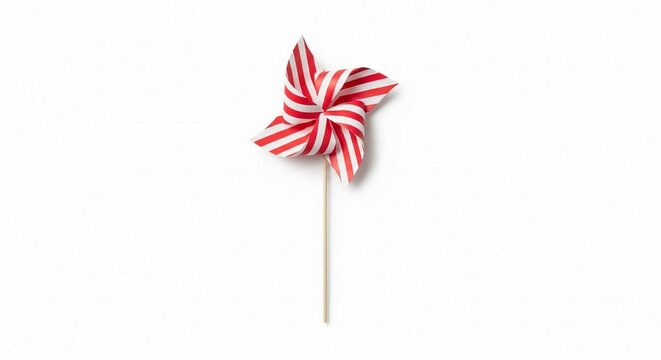 A classic red and white striped paper pinwheel on a stick, isolated and ready for decoration.