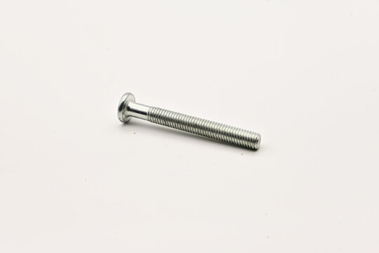 A single metallic screw with a round head and threaded shaft on a white background
