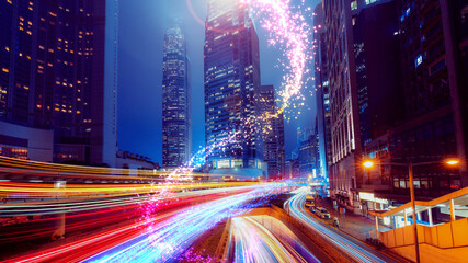 Vibrant, futuristic cityscape of Hong Kong at night with long-exposure light trails. © YiuCheung