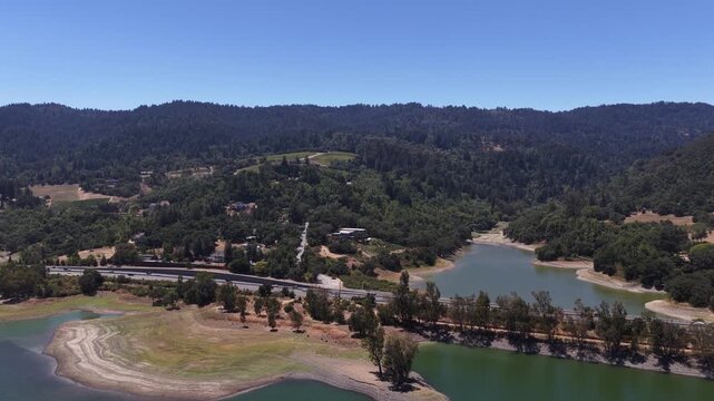 Aerial drone view of the Lexington Reservoir in Los Gatos, California, revealing dangerously low water levels and the dry, cracked lakebed caused by a severe, prolonged drought