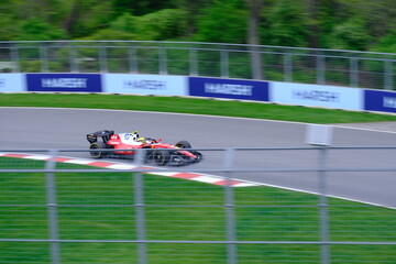 Fototapeta premium May 24, 2025, Montreal, Canada, Charles Leclerc drives Ferrari F1 car at Circuit Gilles Villeneuve. g.