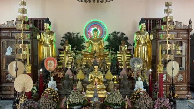 Golden Buddha statues and offerings in a temple in Cambodia