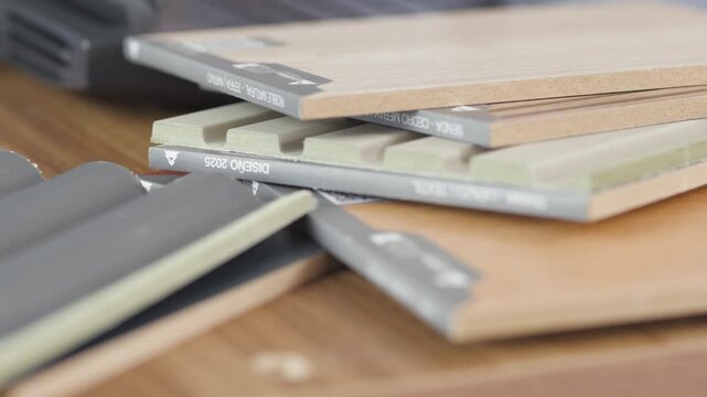 Close-up shot showing several stacked building material sheets with reference labels, textures, and varied tones