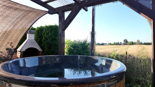 Rustic Outdoor Hot Tub with Fireplace and Countryside View