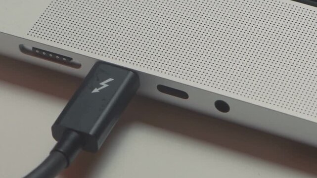 Phone Charging Cable Connected to Laptop Showing Modern Digital Technology