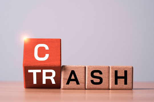 Wooden flipping between Cash and trash concept symbolizes inflation, declining purchasing power, financial risk, currency devaluation, investment strategy, economic uncertainty and money management.