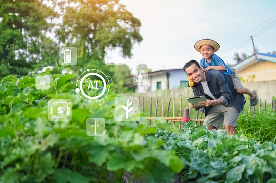 People using Tablet and AI Smart Farmer concept. Father and son using AI technology in organic farming to increase crop production and reduce chemical use.