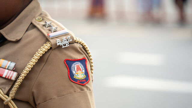 A Tamil Nadu police officer in uniform showing the department emblem - August, 2026, Chennai, India