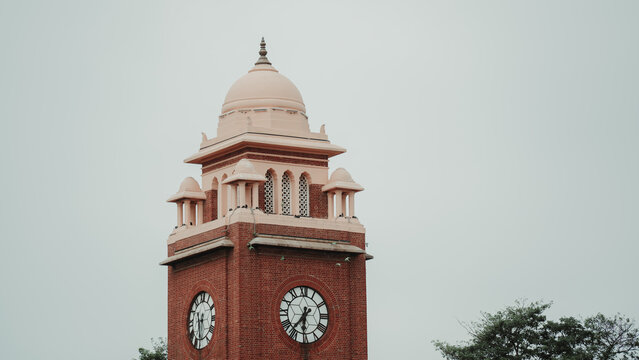 Old Indo-Saracenic heritage clock tower against a cloudy sky