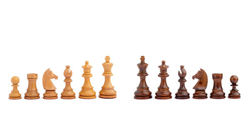 Wooden chess pieces set arranged in a line featuring pawn, rook, knight, bishop, queen, and king isolated on a clean white background. © Renhue