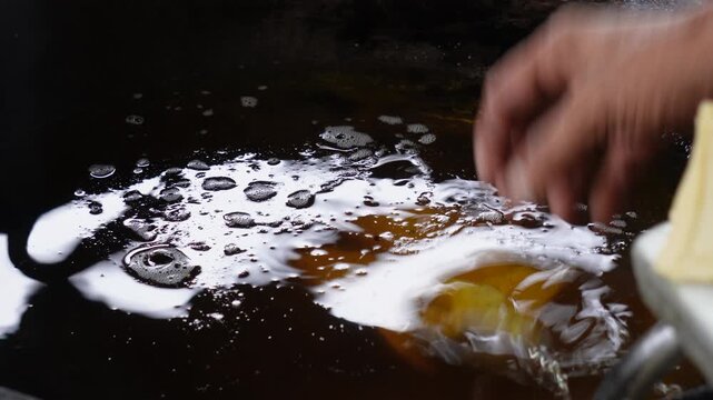 Crispy samosas dropping into sizzling hot oil