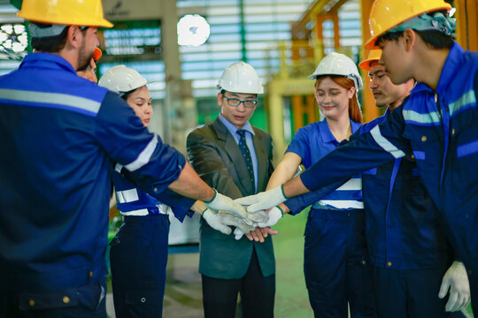 Production manager led team male and female workers assigning tasks effectively and working together in unity to achieve success and meet targets in the automotive parts mold manufacturing plant.