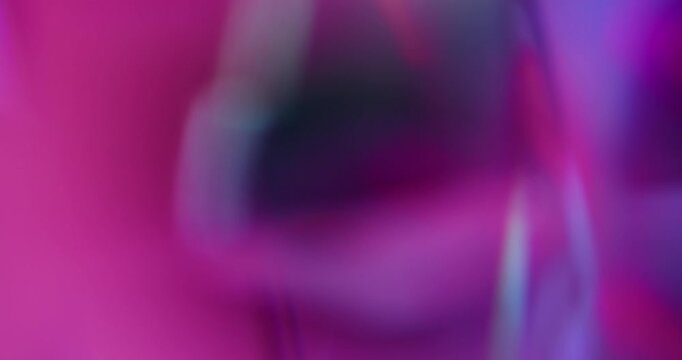 Neon flare. Glass texture. Purple blue pink colorful geometric glare radiant glisten flash on abstract bokeh light art background.