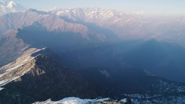 Aerial view of the snow-capped Himalayan mountain range near the Shri Tungnath Temple in Rudraprayag, Uttarakhand, India.