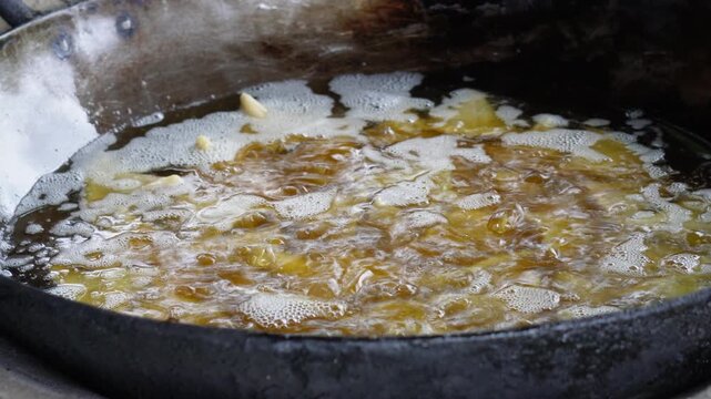 Samosa frying in bubbling hot oil