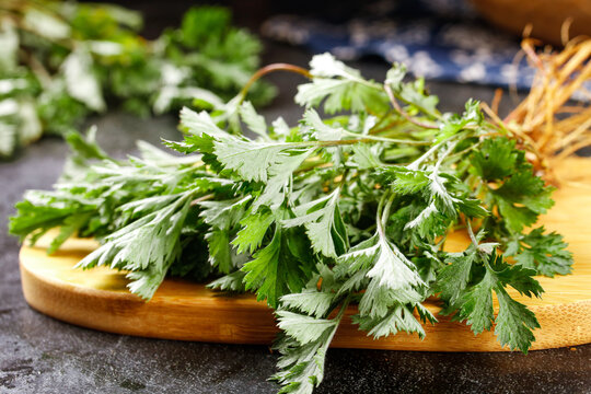 Fresh Green Herbs on Wooden Board - Traditional Chinese Medicine Ingredients for Cooking and Natural Health Remedies