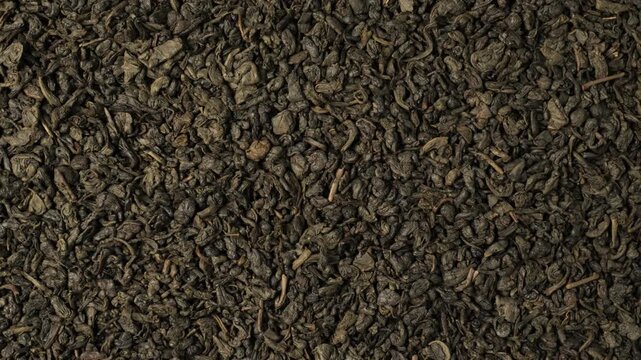 Dried green tea leaves background texture dolly shot