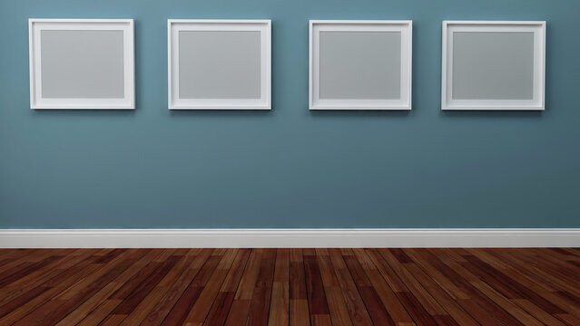 Four empty square picture frames mounted on a teal blue wall above hardwood