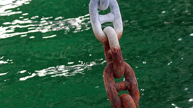 Colors of pier mooring chain and shimmering sea surface, 4K