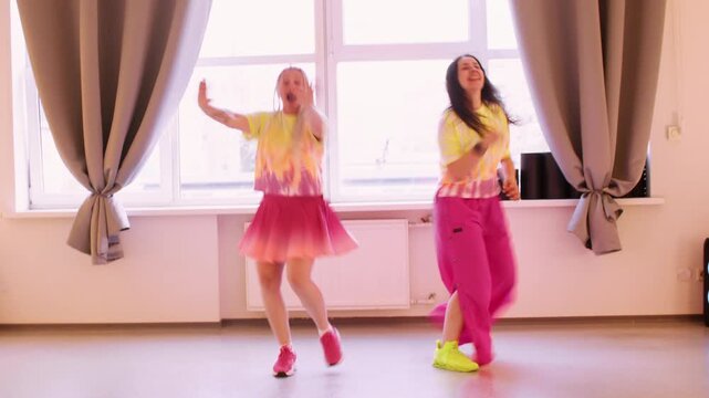 Performer joy. Cheerful rehearsal training. Smiling woman in pink yellow color outfit practicing dynamic show. Festive dancing movement.