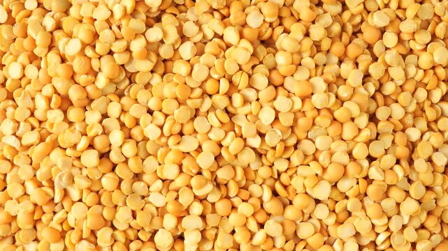 Yellow split peas rotating food background