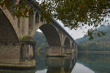Fototapeta premium Historic Stone Arch Bridge over River in Jiande, Hangzhou, China