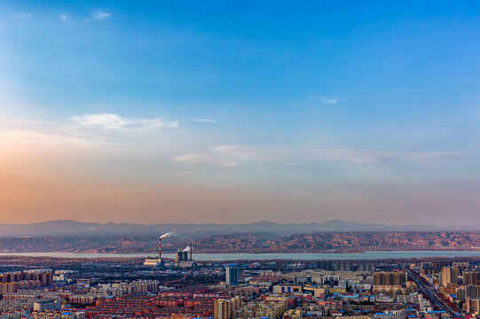 Panoramic Cityscape of Sanmenxia, Henan, China with Riverside Industry and Mountains