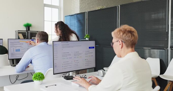 Teacher instructor guides seniors adults student on computer. They pursue learning to build digital skills with guidance for upskilling. Concept classroom training for adult education.