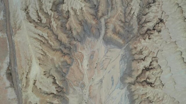 Aerial view of the rugged terrain and dry riverbeds of Mount Zin in the Negev desert, Yeruham, South District, Israel.
