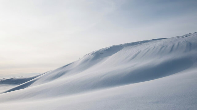 Snowdrift landscape with undulating snow waves in a winter setting