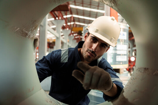 Engineers and staff are inspecting the assembly line system in a metal sheet and metal roofing manufacturing plant.
