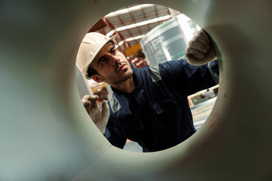 Engineers and staff are inspecting the assembly line system in a metal sheet and metal roofing manufacturing plant.