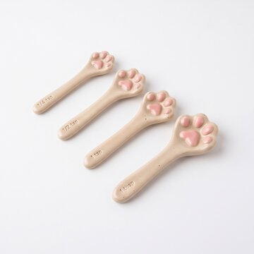 Cute cat paw ceramic measuring spoons set isolated on white background