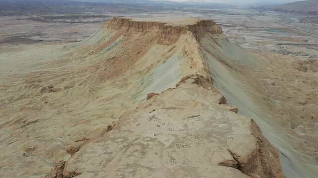 Aerial view of the dramatic cliffs and arid landscape of Mount Zin in the Negev desert, Yeruham, South District, Israel.