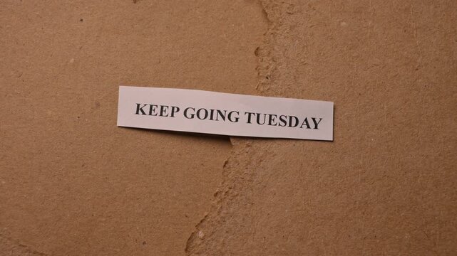 Keep Going Tuesday Inspirational Success Concept on Brown Card Surface