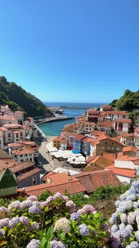 Scenic view of Cudillero coastal fishing village in Asturias Spain with colorful houses harbor sea and flowers