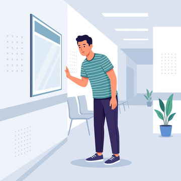 Man peering at framed artwork or notice in a modern, minimalist hallway, perhaps a clinic or office building.