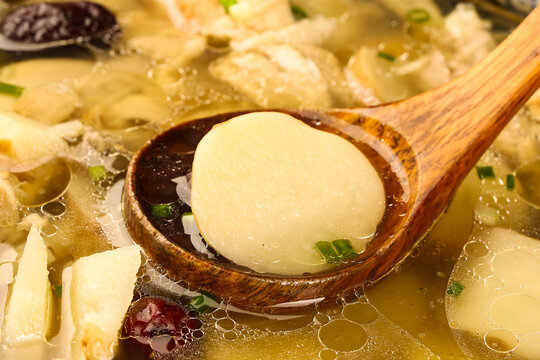 Fresh Dumpling in Wooden Spoon with Nutritious Vegetable Soup - Healthy Asian Cuisine