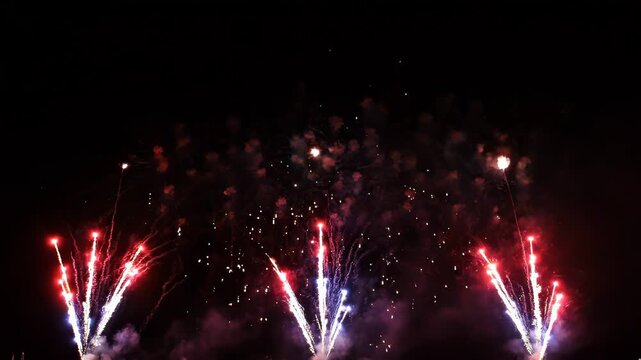 Fireworks exploding in night sky celebration light show motion footage.