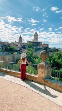 woman admiring view of segovia cathedral and old town in spain