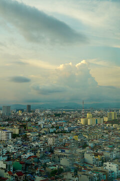 Aerial view of a bustling urban landscape under cloudy skies.