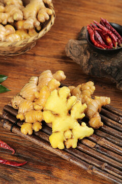 Fresh Ginger Roots with Dried Red Chili Peppers on Rustic Wooden Table