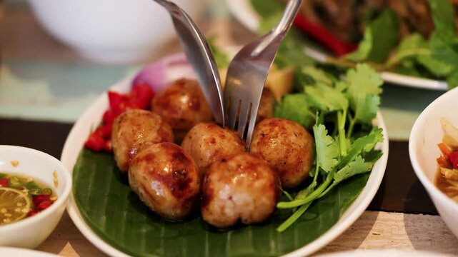 Grilled Sai Krok Isan Fermented Thai Sausages on Banana Leaf