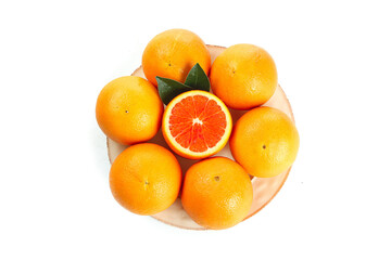 Fresh Blood Oranges on Wooden Plate with Red Interior on White Background © TranThi